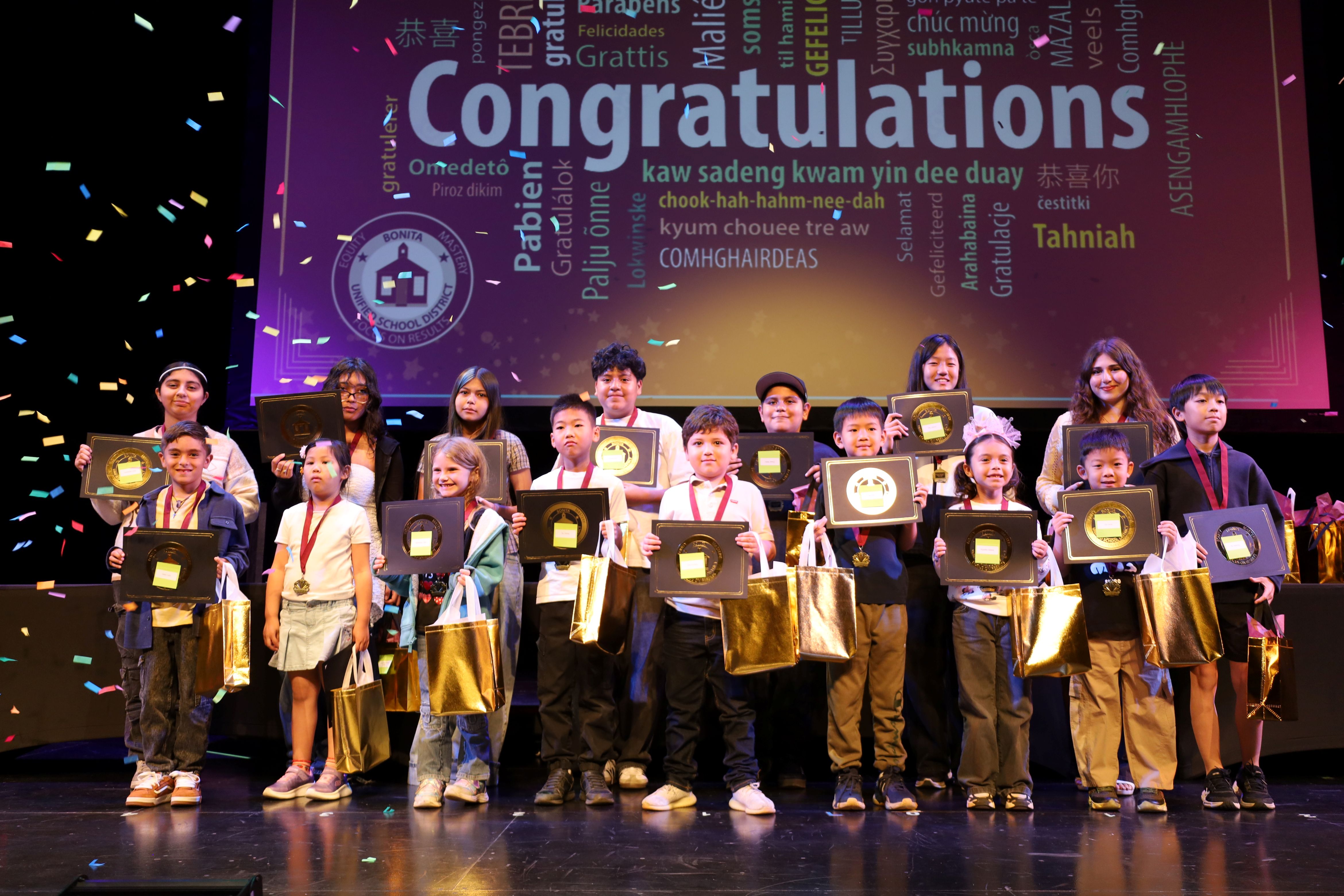 English Learner Student Reclassification Celebration - Students are seen on stage after being recognized for reclassifying as English proficient